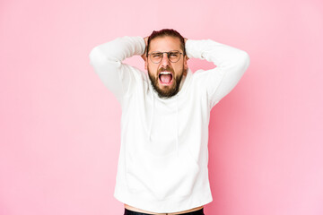 Young man with long hair look screaming with rage.