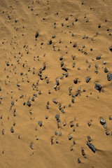 Fototapeta na wymiar crushed granite and sand surface illuminated by sunlight.