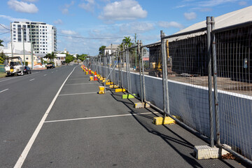 Temporary security fencing in front of demolition site.