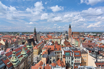 Fototapeta na wymiar Wroclaw, Poland. High angle view on Market Square with Old Town Hall, St. Elizabeth's Church and western part of the city. View from a bridge between towers of St. Mary Magdalene Church.