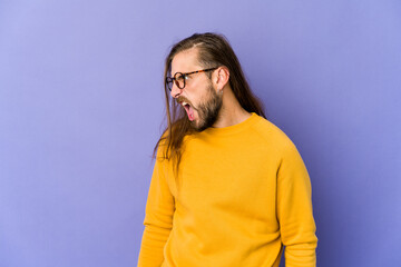 Fototapeta premium Young man with long hair look shouting very angry, rage concept, frustrated.