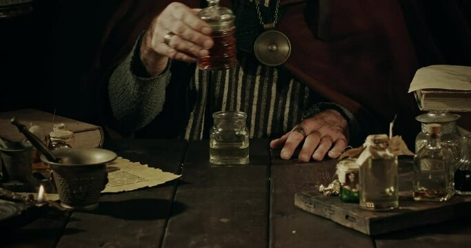 Alchemist and herbalist working in his laboratory