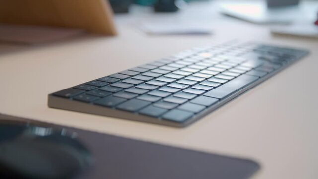 male hands typing on computer keyboard and mouse