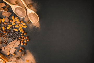 Chocolate background from different types of nuts, chocolate slices, coffee beans and cocoa. Copy space. Banner.