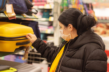 Fototapeta premium Woman in protective mask, supermarket, things