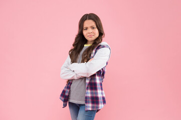 Confident kid with pouty look keep arms crossed in casual fashion style pink background, confidence