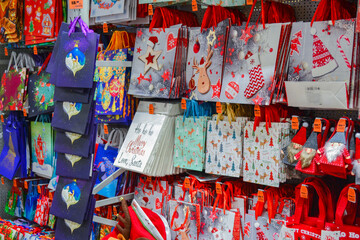 Moscow, Russia, November 2019: a Lot of paper gift bags for new year and Christmas gifts with bright patterns, red color are sold in the store