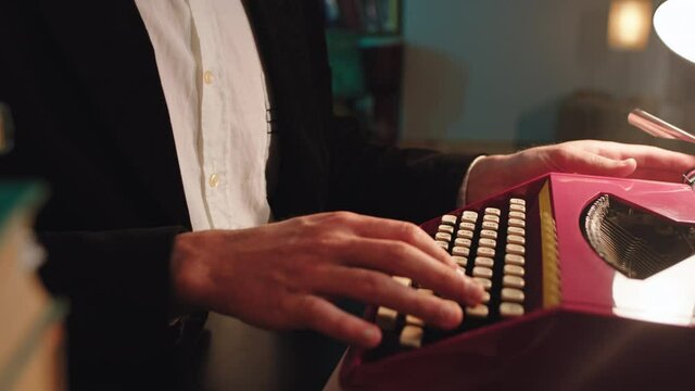 Retro pink typewriter in the library details man type some text on the white paper