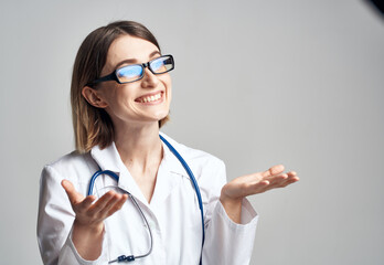 portrait of female nurse in medical gown and blue stethoscope cropped view