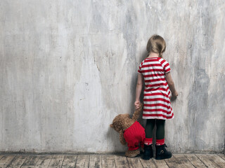 Offended, punished child at the wall - obrazy, fototapety, plakaty
