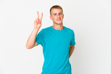 Young caucasian handsome man showing victory sign and smiling broadly.