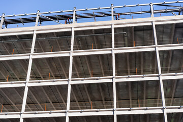 Detail of multilevel modern office building under construction with visible steel frame, Silicon Valley, California