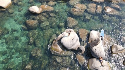 Lovers relaxing in the crystal clear lake