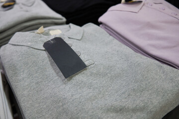 Blank multi colored polo t-shirts with labels at store counter