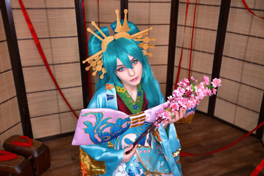 Cute white teenage girl cosplaying miku character Japan style