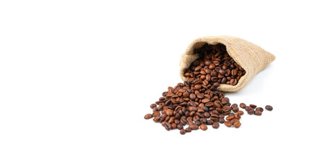 Spilling coffee beans from a linen bag isolated on a white background. Side view, panorama. Coffee background.