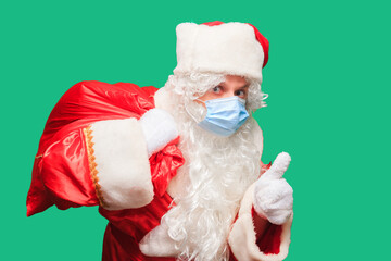 Santa Claus wears a paper Face Mask due to Covid-19. Coronavirus is dangerous and is world wide.