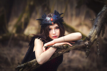 Cute young girl in dark dress fairy elf creature