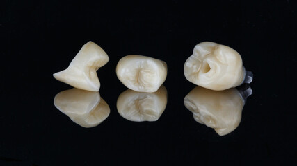 ceramic crowns on mirror with reflection with black background
