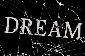 gloomy broken glass with cracks with the inscription dream