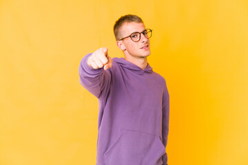 Young caucasian handsome man cheerful smiles pointing to front.