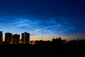 Noctilucent clouds (night shining clouds) in the night sky over the city. July 2020 - Obninsk, Russia
