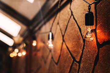 Warm light bulbs against a brown textured wall