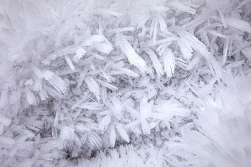 Close-up of hoar frost texture. Winter background with rime ice crystals. Cold temperature, frost structure.