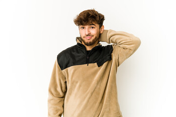 Young arab man on white background touching back of head, thinking and making a choice.