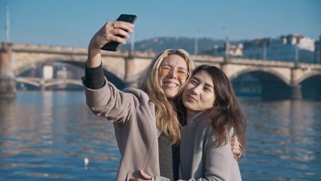Two lesbian friends taking selfie in Prague city. Pride, lgbt, love wins, tolerance, gay concept. Filmed on REd 4k, 10 bit color