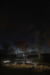Silver bullet water tank at night