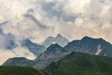 Naklejka premium Beautiful mountain landscape at Caucasus mountains with clouds in the sky