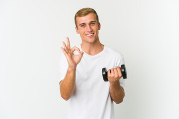 Young caucasian man holding a weight isolated on white background