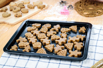 Homemade Christmas ginger bread cookies, Xmas gingerbread cookie on tray, preparing bakery, process of baking and cooking at home