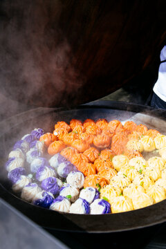 Colorful dumplings cooking in wok