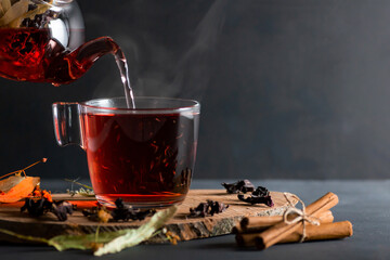 Winter herbs and spices tea in glass teapot or mug, alternative medicine for the immune system, herbal hot drink concept