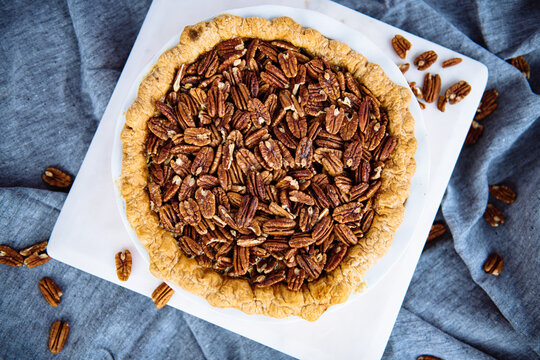 Overhead view of pecan pie on cutting board