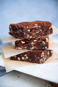 Close up of fudge walnut brownie slices on table