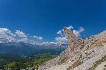 Fototapeta premium Bizarre shaped rocky peak near a hiking trail with awesome dolomite mountains background, Settsass, Dolomites, Italy