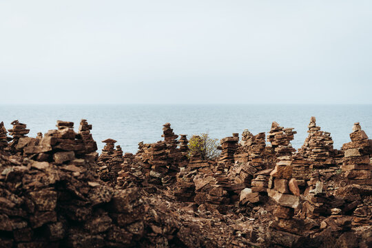 View of rock stacks by sea against sky