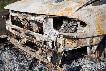 Burned down car, abstract background, selective focus. The situation of protests in the world.
