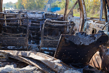 Burned down car, abstract background, selective focus. The situation of protests in the world.