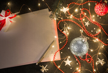 Preparation for New Year's or Christmas greetings. Dark background, girlyadna and christmas decorations.