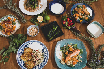 Grilled vegetables and healthy food dishes on a fancy wooden table. Mediterranean food dishes with asparagus, tofu, seitan and Halloumi cheese. Gluten free recipes for fitness persons. Food Background