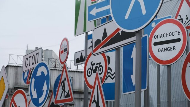 A lot of decorative road signs in one place. Customs, turn only right, speed limit, parking prohibited, roundabout, reverse traffic, stop, overtaking prohibited