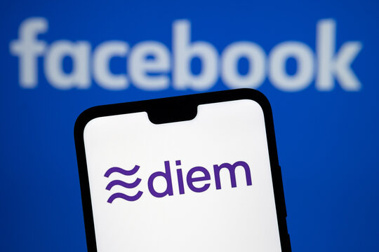 Stafford, United Kingdom - December 1 2020: Diem Currency Logo On The Smartphone Silhouette And Blurred Facebook Logo On The Background. Diem Is Rebranded Libra Crypto  Currency.