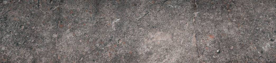 Panoramic view of details of the eroded surface of the old concrete wall.
