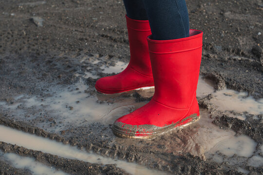 Red Rain Boots In A Mud Puddle