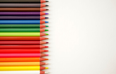 Multicolored pencils on white background