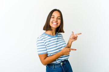 Young mixed race woman excited pointing with forefingers away.